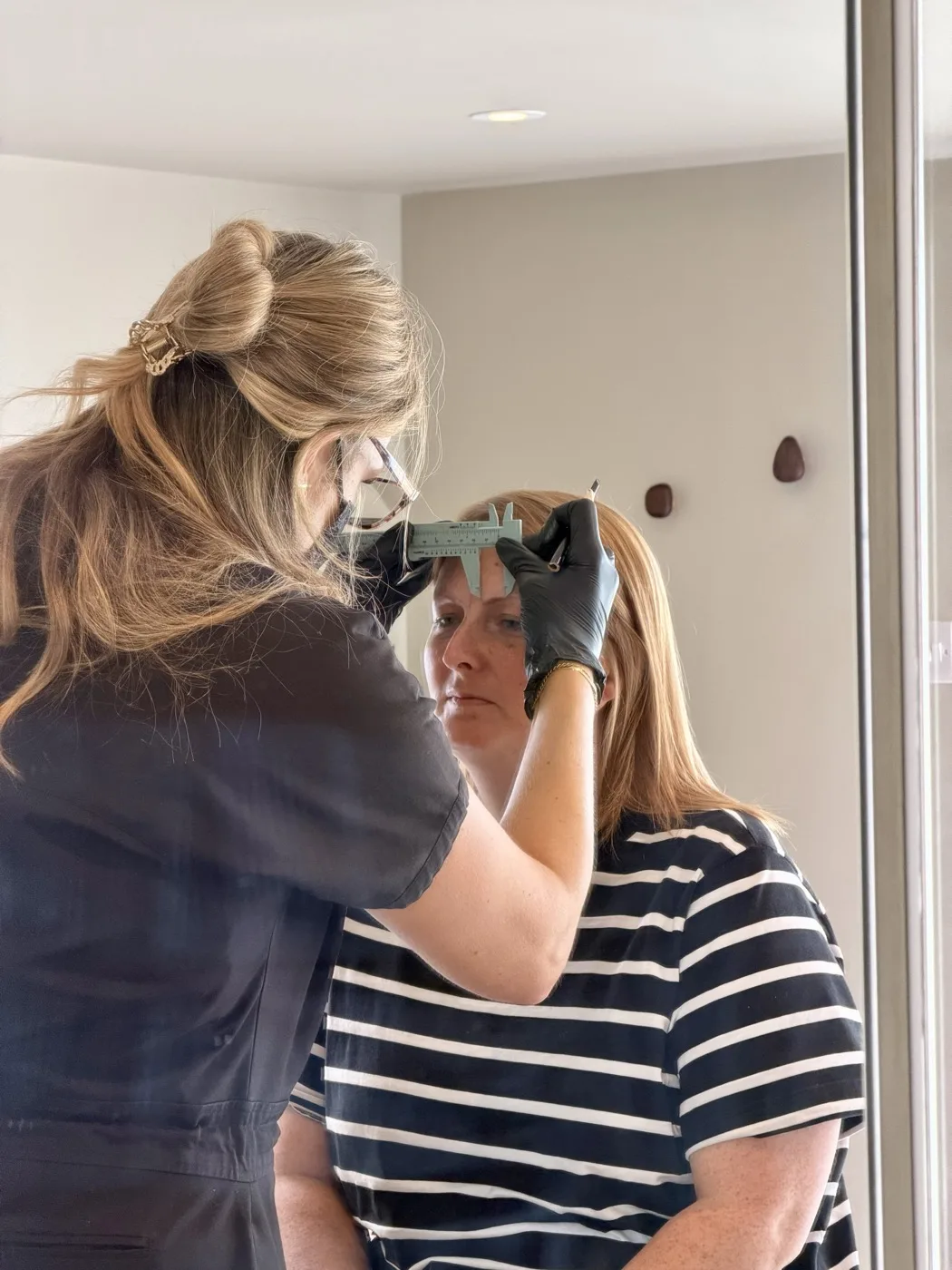 Sophie prepping a client before treatment